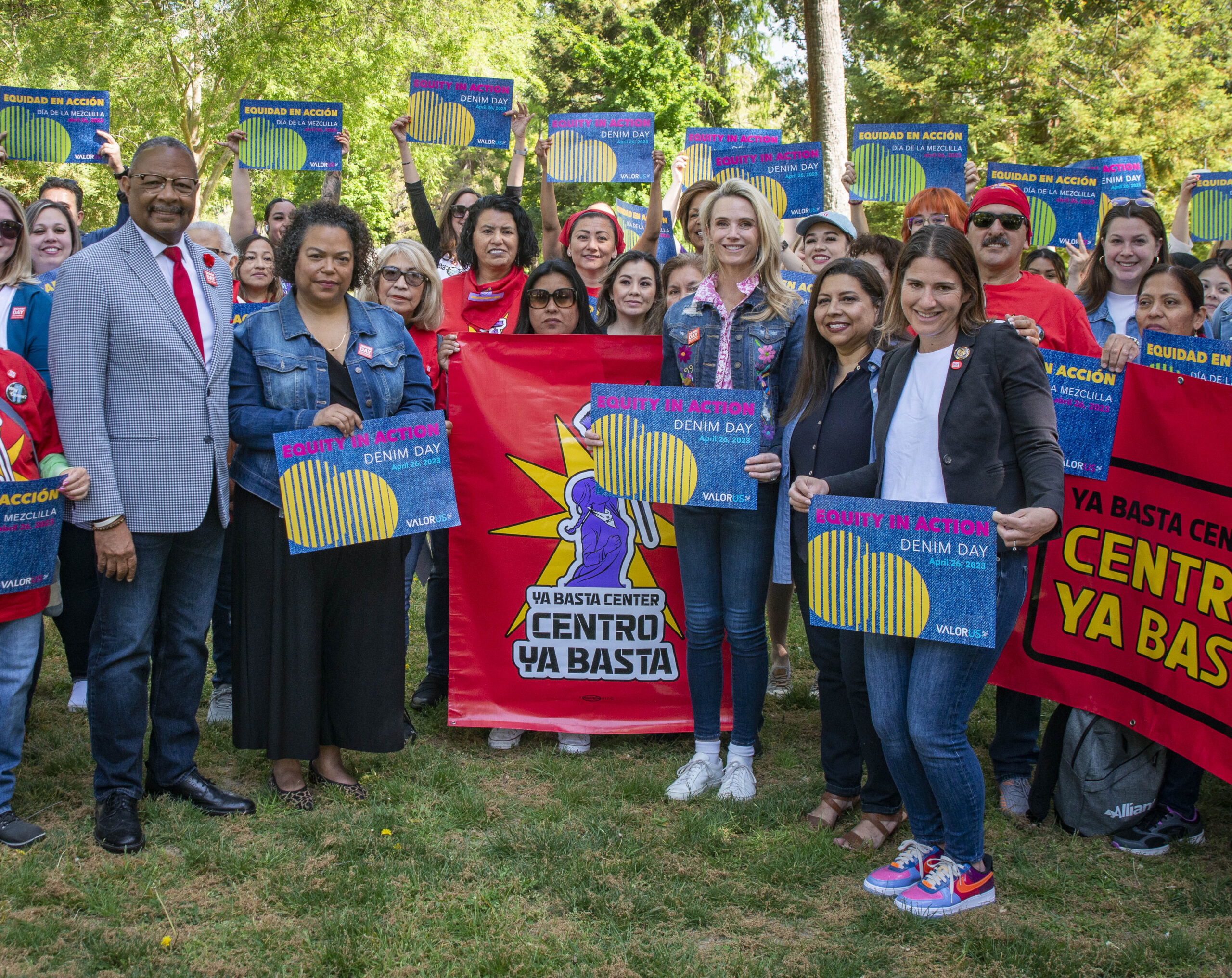VALOR’s CEO, Sandra Henriquez, standing next to the First Partner of California and Assemblymembers Bauer-Kahan, Bonta, and Jones-Sawyer. Members from the ¡Ya Basta! Center are standing behind them holding up Denim Day signs.